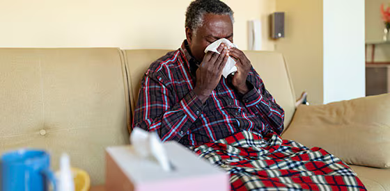 man blowing nose